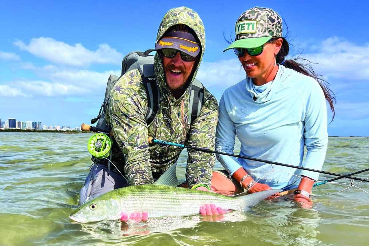 Hilary Hutcheson and fishing guide hold a bonefish.