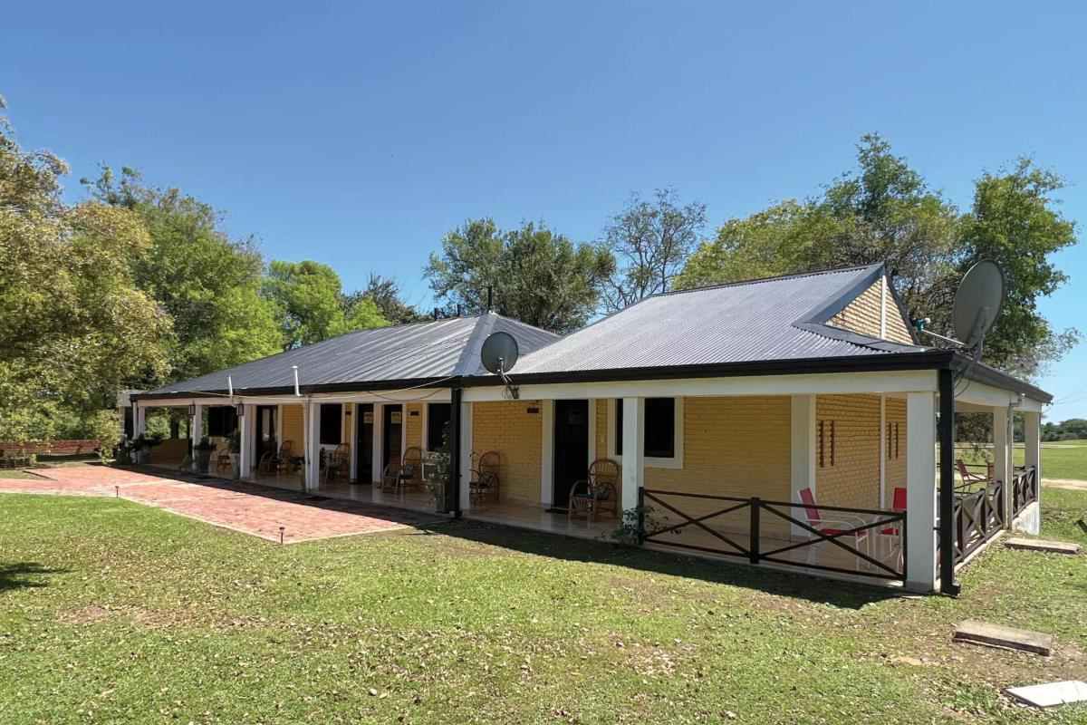 A one-story yellow motel-style fishing lodge.