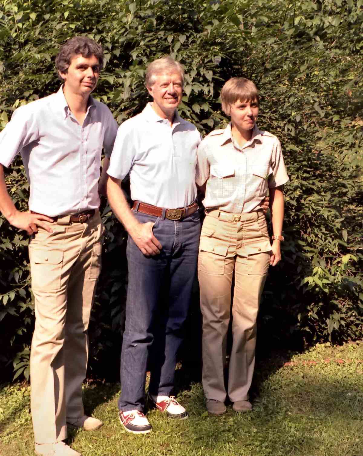 Barry Beck, Jimmy Carter, and Cathy Beck smile for the camera.