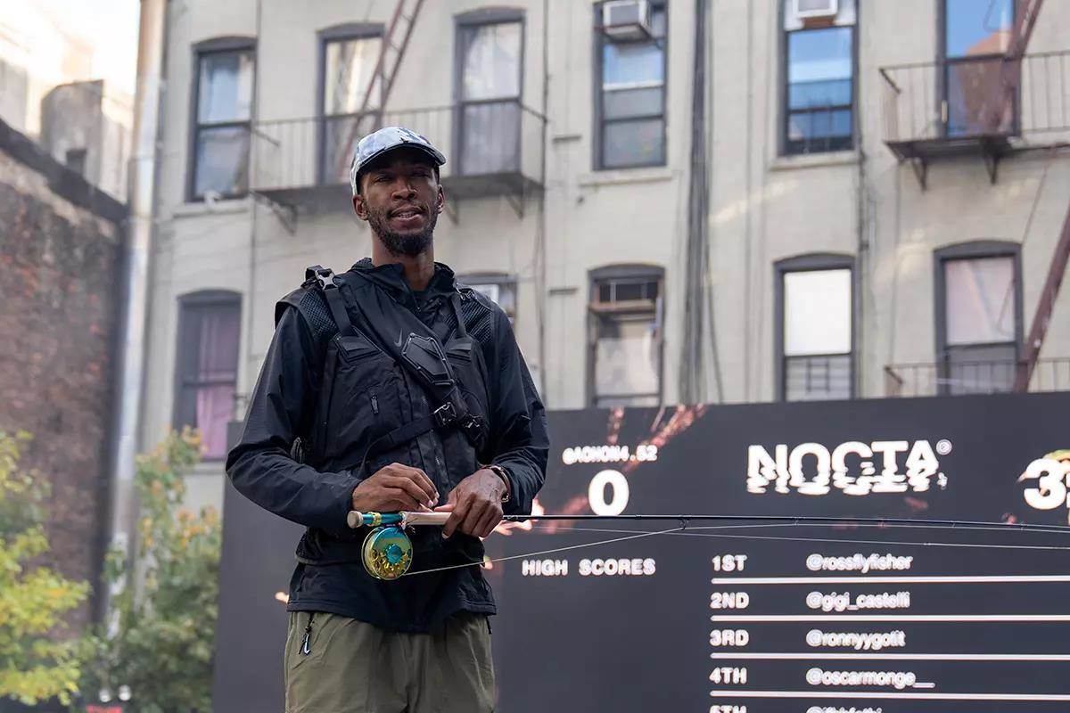 Eeland Stribling holds a fly rod and reel at an event in New York City.