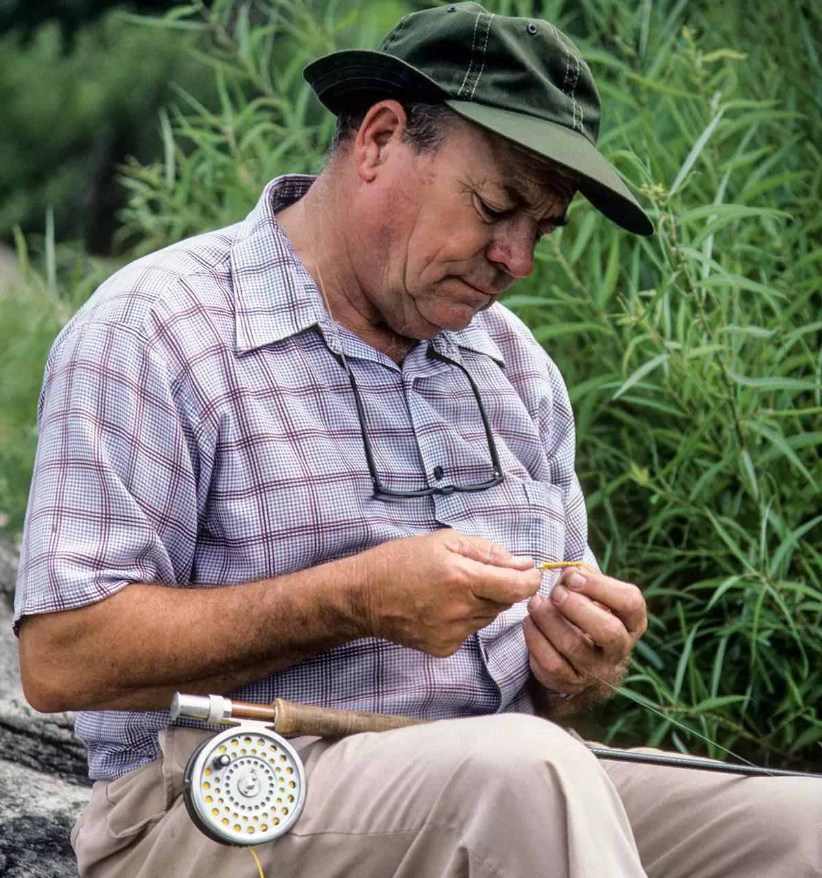 Lefty Kreh tying a fly onto his leader. 