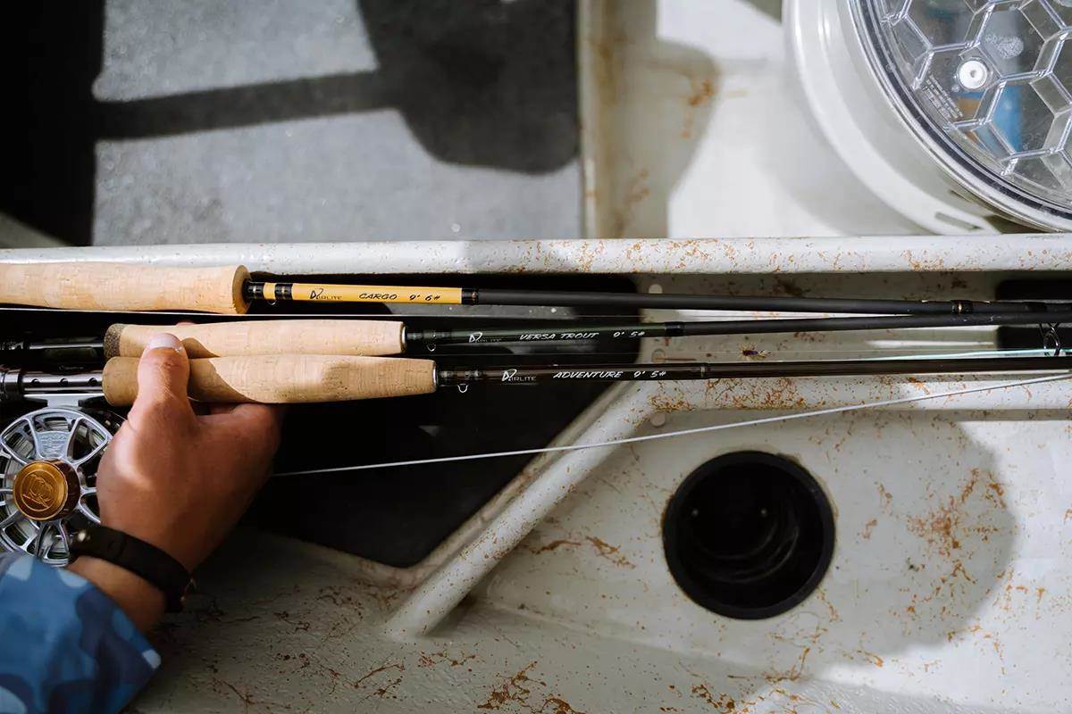 A pile of Airlite fly rods and reels on the fiberglass of a drift boat. 
