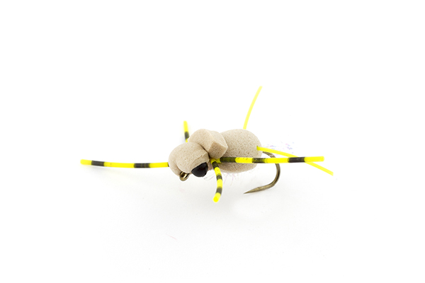 A tan foam fly with black and yellow rubber legs