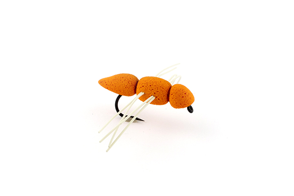 an orange foam fly with white rubber legs